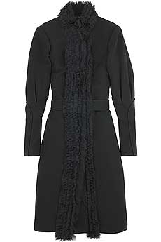 Black wool single-breasted ruffle collar coat with a petal detail on leg of mutton shaped sleeves.