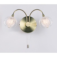 A stylish and modern switched wall light fitting in an antique brass finish with clear moulded glass