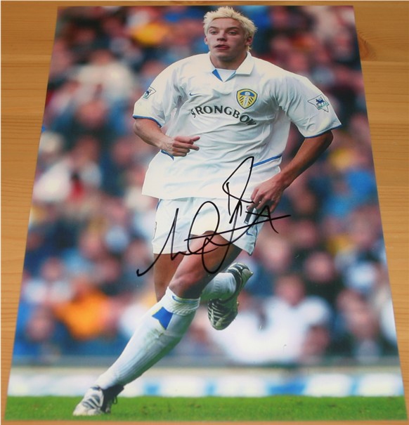 Signed in black pen by former Leeds United striker and hero Alan Smith. COA - 0420000476