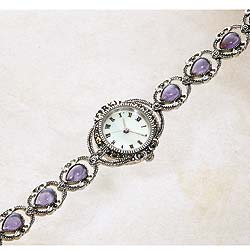 Cabouchons of amethyst studded with glittering marcasite make up the delicate strap of our watch