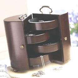 This stylish wooden jewellery box with brass handles opens to reveal felt lined trays that will