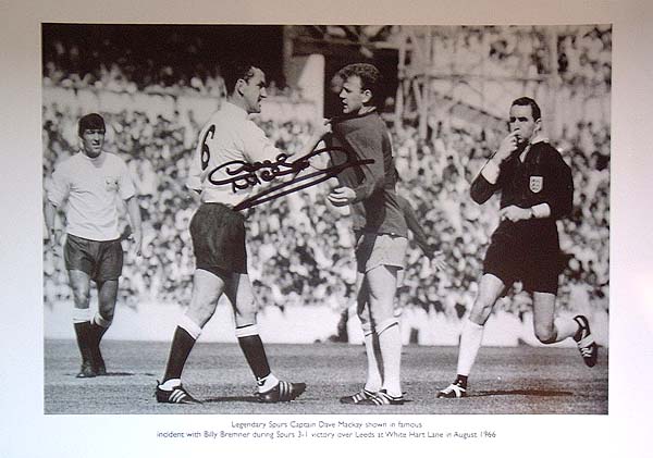 This superb print shows the legendary Spurs captain Dave Mackay confronting Billy Bremner of Leeds a