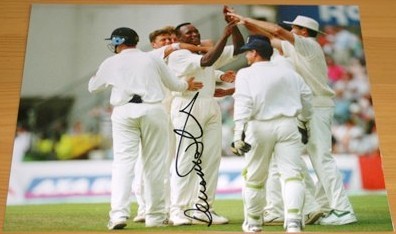 Great colour photo signed by Devon Malcolm during his match winning spell of 9-57 against South