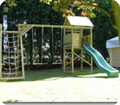 Substantial timber climbing frame including fort with roof, 10ft wave slide, double swing beam,