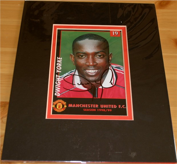 Black and white photocard signed by former Manchester United striker Dwight Yorke in black pen. The