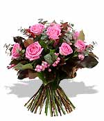 One last blush of summer passion Balmy pink roses flirt brilliantly with bead-like berries and