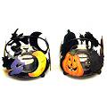 A set of two Halloween candle holders, decorated w