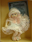 This delightful little baby girl in 1:12 scale has a soft cloth body and porcelain head, arms and
