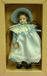 By Heidi Ott, this lovely little girl is dressed in a sky blue and lace dress and bonnet
