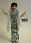 By Heidi Ott, this lovely modern lady in long sky blue silk evening dress carries a feather boa and