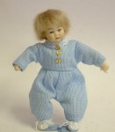 By Heidi Ott, this lovely little boy is dressed in a blue striped suit and white knitted