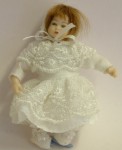 By Heidi Ott, this lovely little girl toddler is dressed in white lace with a lace bonnet and