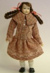 By Heidi Ott, this lovely little Victorian girl figure is dressed in outdoor clothes