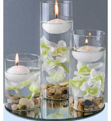 Set of 3 Floating Candles in ivory include individual flowers and pebbles. which sit on a circular mirror base; a lovely way to add some elegance to your home. Burn time of 3 hours. Size H19.5. W6.5. D6.5cm. EAN: 1738711.