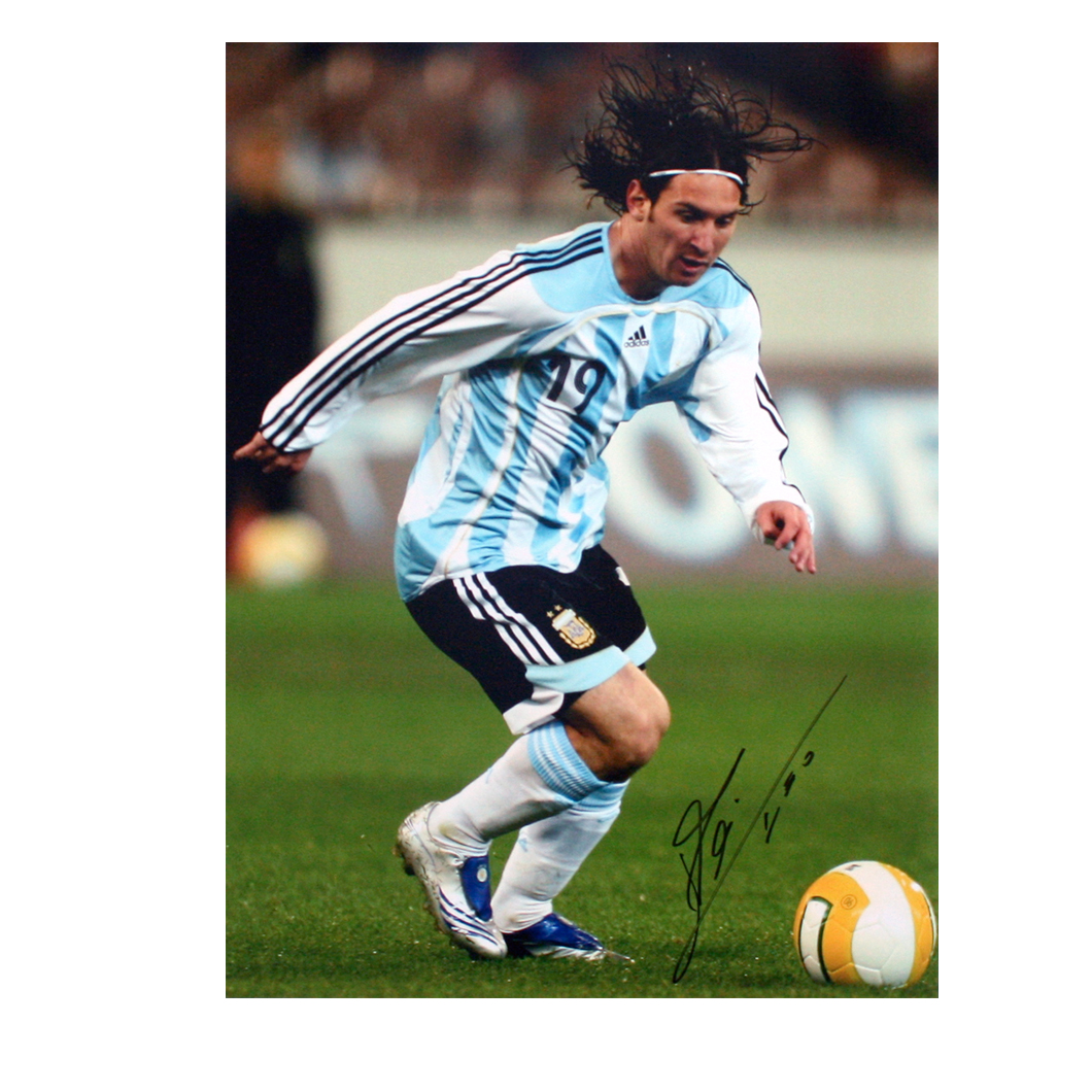This signed photo shows Lionel Messi shooting for goal during an international for Argentina against