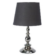 This candlestick table lamp has a gunmetal finish. It features a white cotton shade so it will fit n