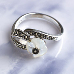 Silver and marcasite ring with a carved mother-of-pearl flower