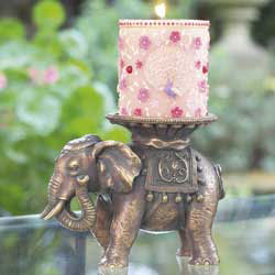 Richly decorated peacock candle and elephant candle holder. Created exclusively for Past Times