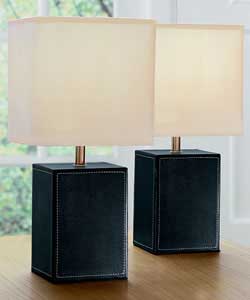 Black leather base with a cream fabric shade.In-line on/off switch.Height 32cm.Shade diameter