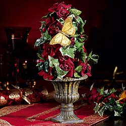 Deep red roses and ivy make up these delightful decorations adorned with a golden butterfly