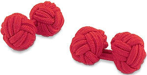 A pair of plain red knot elasticated cufflinks.