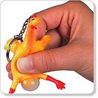 Lightly squeeze the rubber belly of the rather disturbing miniature chicken (9 x 5)cm and an `egg` w