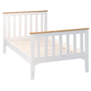 A solid pine bedstead in traditional style, with w