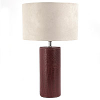A contemporary table lamp with a deep red crocodile style faux leather cylindrical base and a plain 