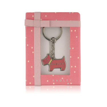A solid Radley dog enamel keyring which is gift wrapped in a bright pink patterned box with a pale p