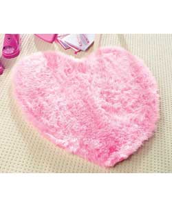 Faux fur heart shaped rug in bright pink.Polyamide