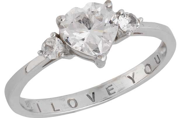 This silver dress ring features three cubic zirconia stones with the centre stone in an adorable heart shape. The inner band is engraved with I Love You so would be the perfect gift for the one you love. Cubic zirconia stone set. Available in sizes L