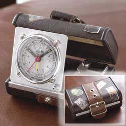 Open this miniature suitcase to find an alarm clock- the perfect traveling accessory. Quartz