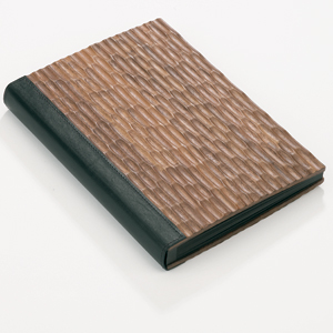The Mirage Album has a beautifully carved pattern cover in solid walnut, with a leather spine and