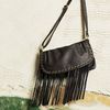Soft leather flap-over style with brushed gold eyelet and fringing detail. Popper fastening and insi