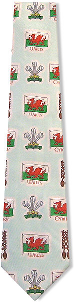 A lovley tie featuring the Wales flag, prince of Wales crest and lovespoons on a mint green backgrou