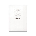 An embossed white heart centres on a luxurious white card
