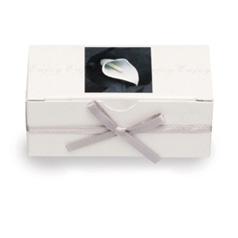 This elegant white favour box with cala lily detail contains two of Thorntons finest Continental cho